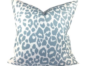 blue sky Iconic Leopard outdoor pillow against a white background
