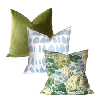 3 pillow of Schumacher Hydrangea and Queen of Spain and green velvet pillows in descending order against a white background